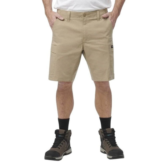 Person wearing beige shorts with a white background