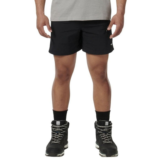 Person wearing black shorts and black hiking boots on a white background