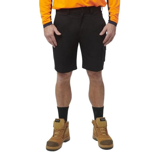 Person wearing black shorts, orange shirt, and brown boots on a white background