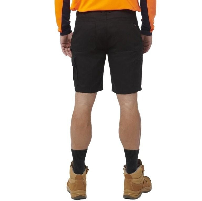 Person wearing black shorts, orange shirt, and brown boots on a white background