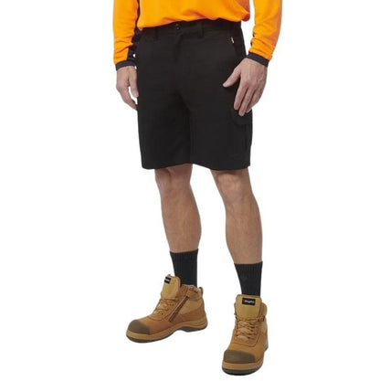 Person wearing black shorts, orange shirt, and brown boots on a white background