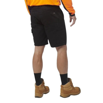 Person wearing black shorts, orange shirt, and brown boots on a white background