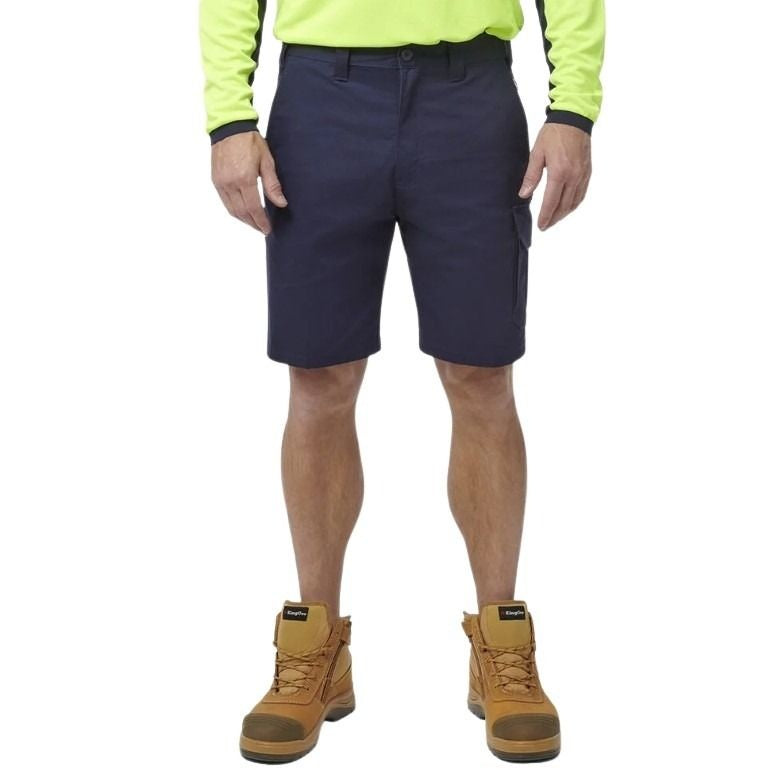 Person wearing navy shorts, yellow long-sleeve shirt, and brown boots on a white background