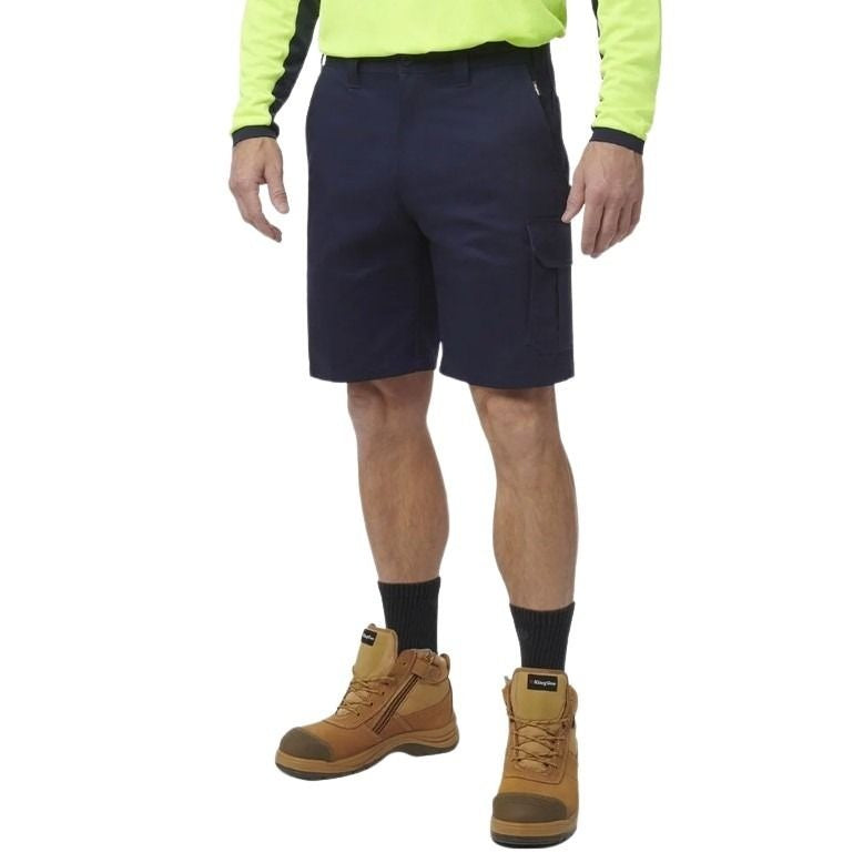 Person wearing navy shorts, a bright yellow long-sleeve shirt, and brown work boots on a white background