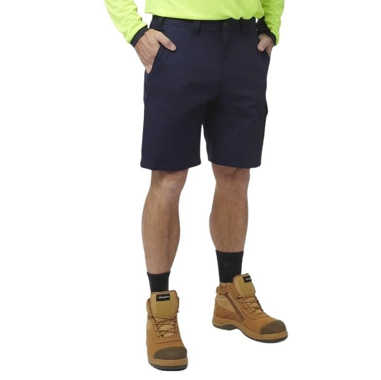 Person wearing navy shorts, brown boots, and a bright yellow shirt on a white background