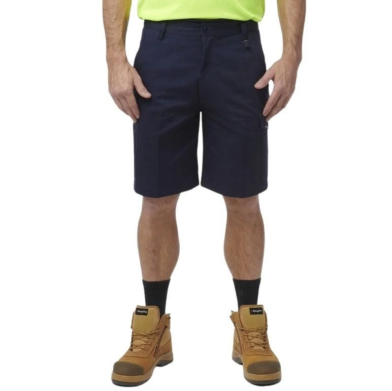 Person wearing navy shorts, yellow shirt, and brown boots on a white background