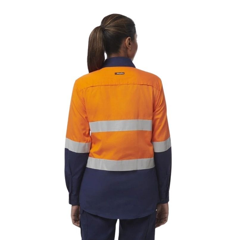 Person wearing an orange and navy high-visibility work shirt on a white background