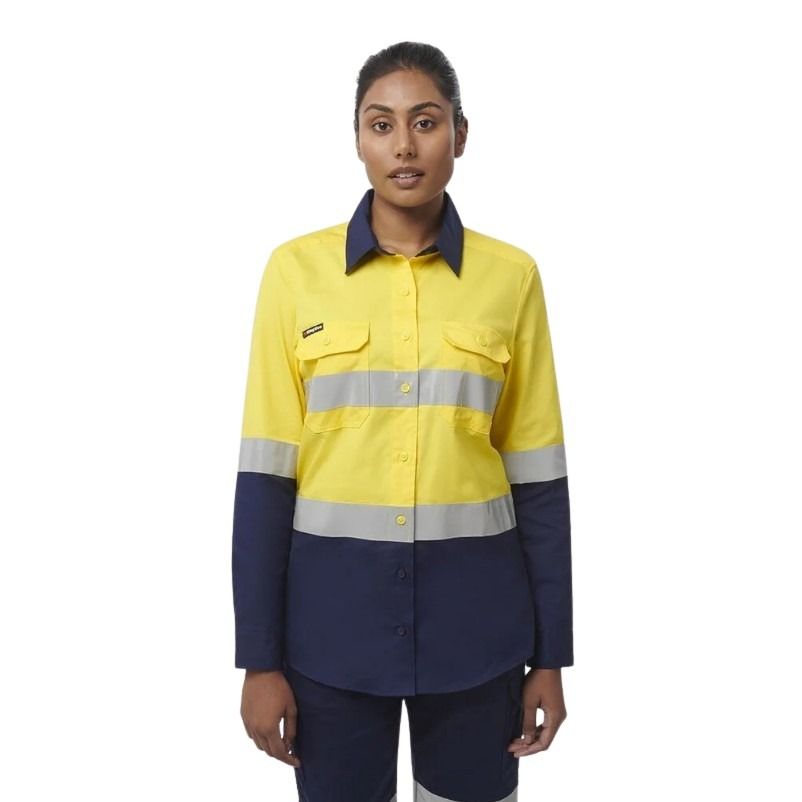 Person wearing a yellow and navy work shirt with reflective stripes on a white background