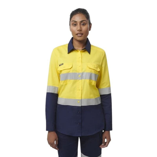 Person wearing a yellow and navy work shirt with reflective stripes on a white background
