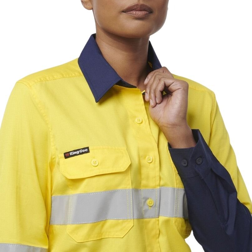 Person wearing a yellow work shirt with a visible brand logo on a white background