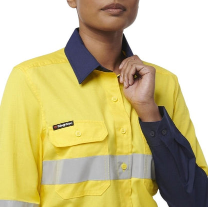 Person wearing a yellow work shirt with a visible brand logo on a white background