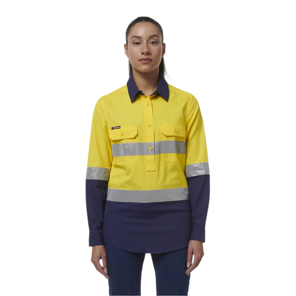 Person wearing a yellow and navy work shirt with reflective stripes on a white background