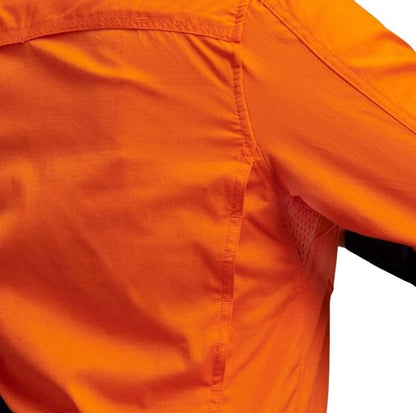 Close-up of an orange shirt with a white background