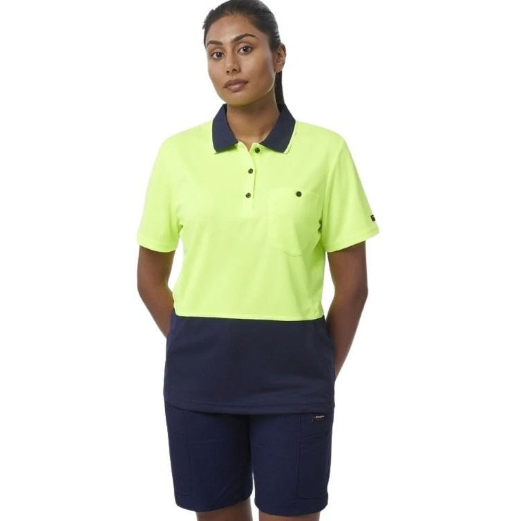 Person wearing a bright yellow polo shirt with navy collar and navy shorts on a white background