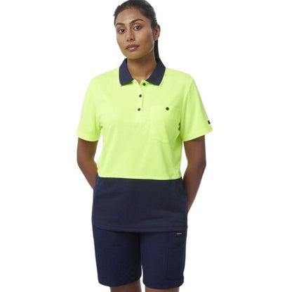 Person wearing a bright yellow polo shirt with navy collar and navy shorts on a white background