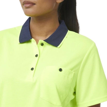 Person wearing a bright green polo shirt with a navy collar on a white background