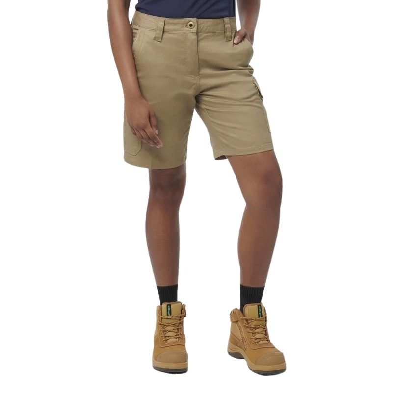 Person wearing beige shorts and brown boots on a white background