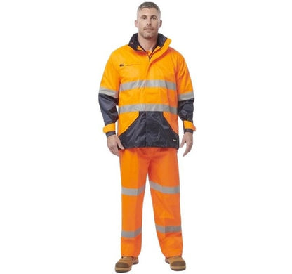 Person wearing an orange and black high-visibility work suit on a white background