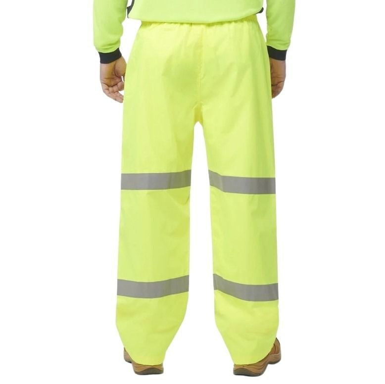 High-visibility yellow work pants with reflective stripes on a white background