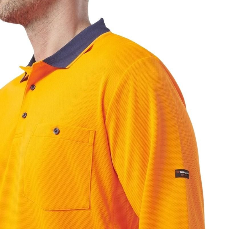 Orange and navy spliced long sleeve polo shirt with one pocket and button down on a white background