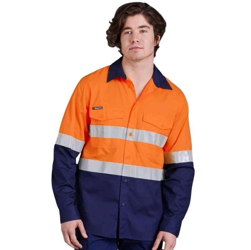Person wearing an orange and navy work shirt with reflective stripes on a white background
