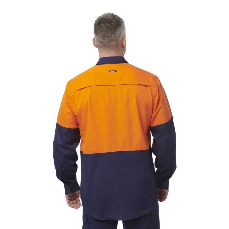 Person wearing a two-tone orange and navy work shirt on a white background
