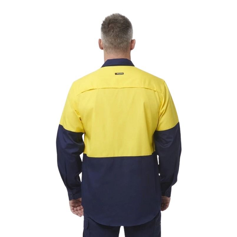 Person wearing a yellow and navy work shirt on a white background