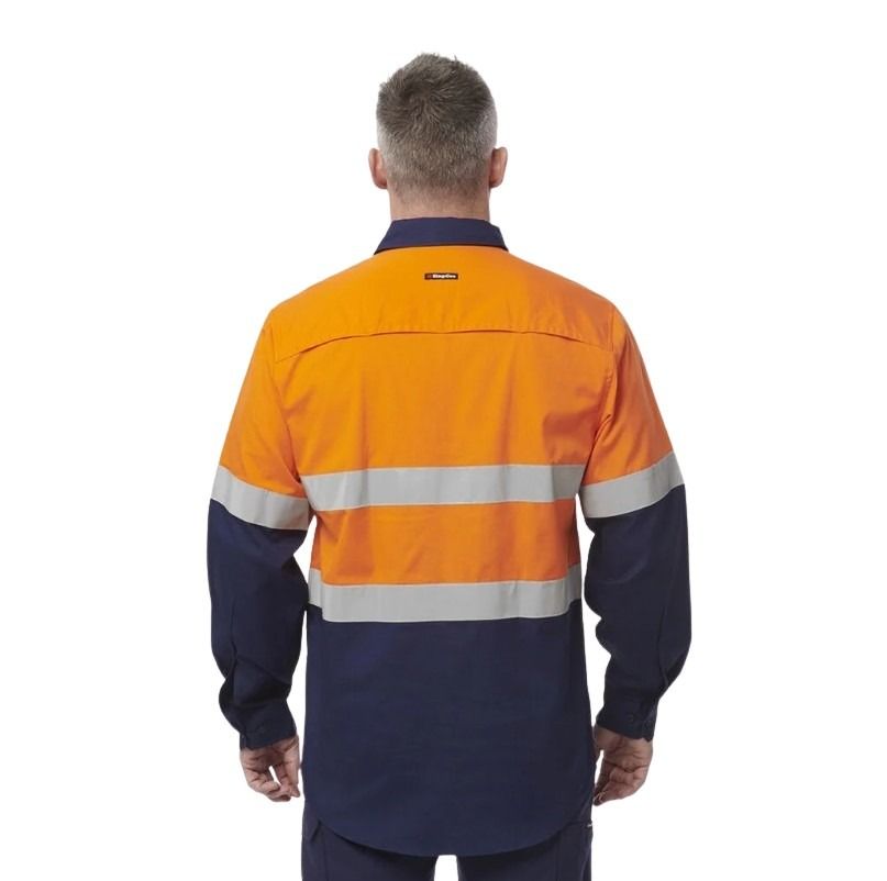 Person wearing a high-visibility work shirt with orange and navy colors on a white background