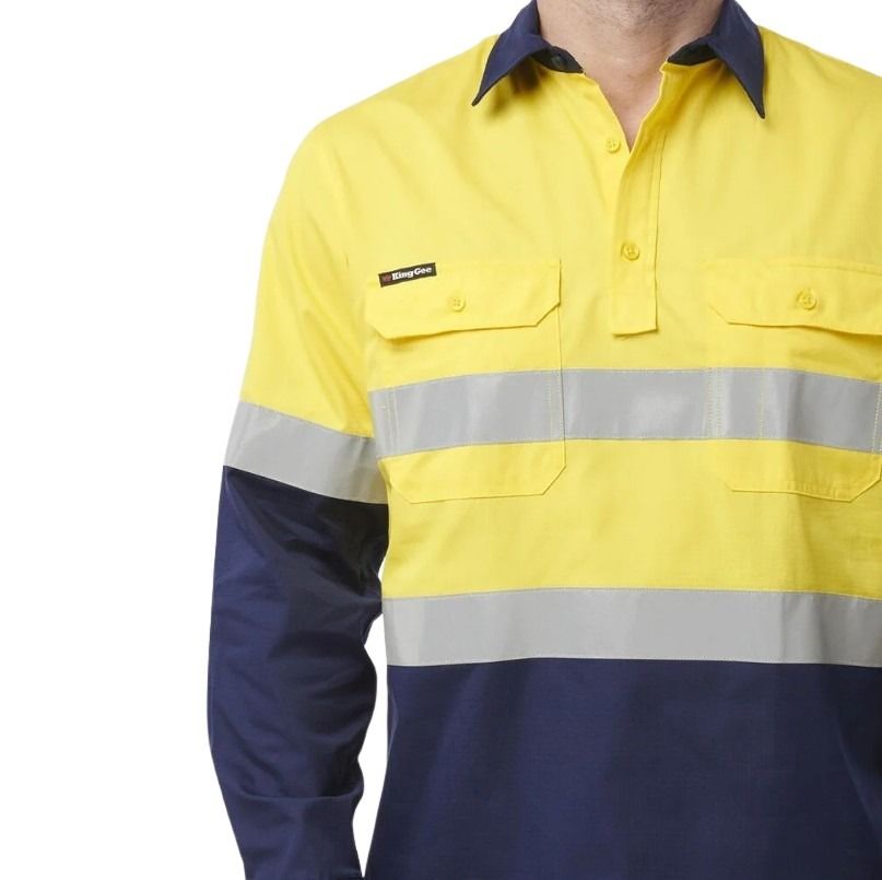 Yellow and navy work shirt with reflective stripes on a white background