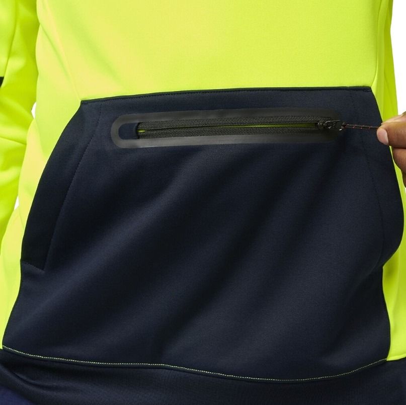 Close-up of a person wearing a high-visibility jacket with a black pocket.
