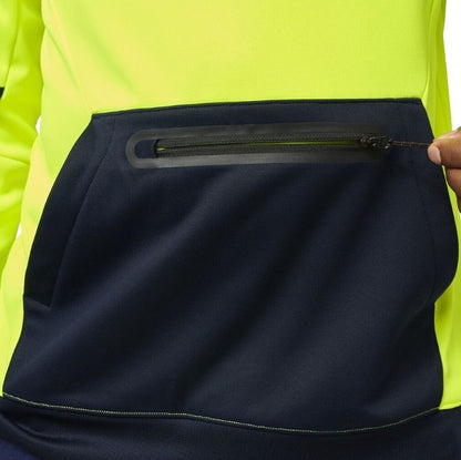 Close-up of a person wearing a high-visibility jacket with a black pocket.
