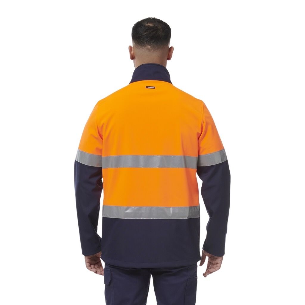 Person wearing an orange and navy high-visibility work jacket on a white background