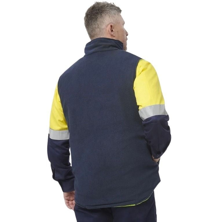 Person wearing a navy and yellow work jacket with reflective stripes on a white background