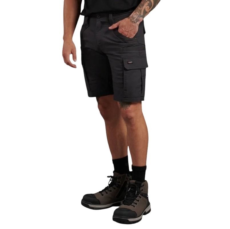 Person wearing black cargo shorts and hiking boots on a white background