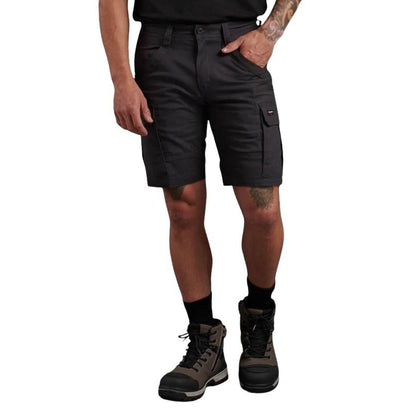 Person wearing black cargo shorts and hiking boots on a white background