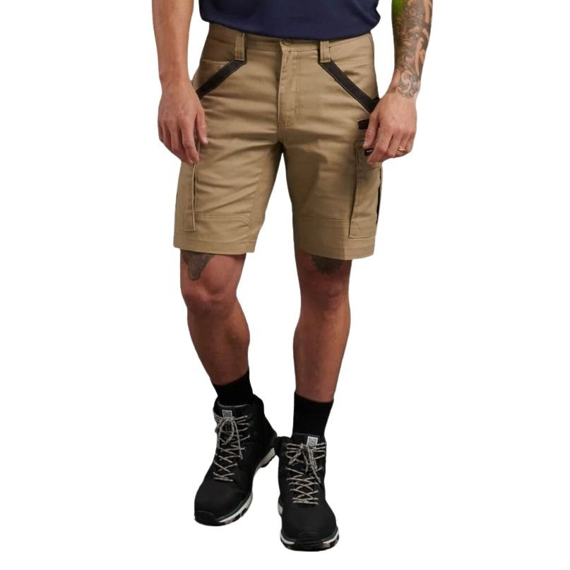 Person wearing beige cargo shorts with black accents on a white background
