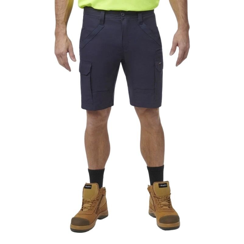Person wearing navy cargo shorts with a white background