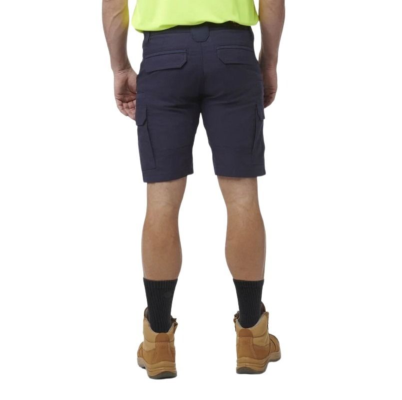 Person wearing navy cargo shorts on a white background