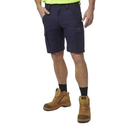 Navy cargo shorts worn by a person with brown work boots on a white background