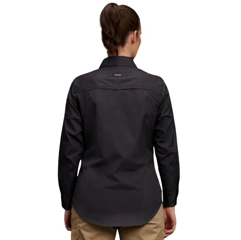 Person wearing a black shirt with a visible brand logo on a white background
