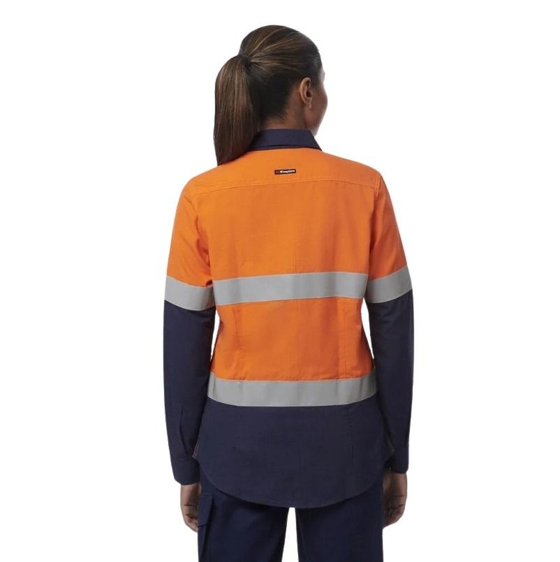 Person wearing an orange and navy work shirt with reflective stripes on a white background
