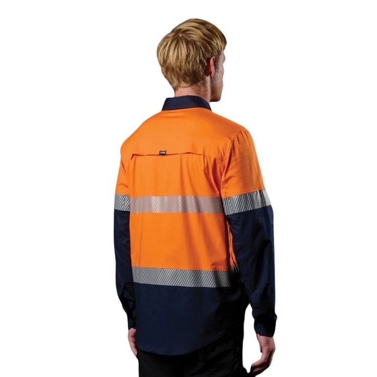 Person wearing an orange and navy high-visibility work shirt on a white background