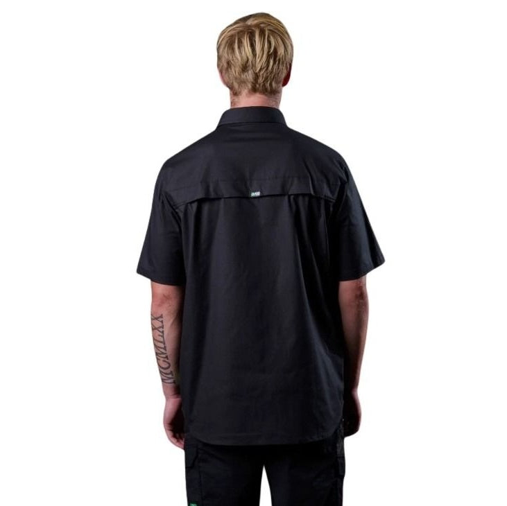 Person wearing a black shirt with a visible brand logo on a white background