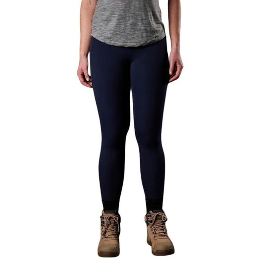 Person wearing navy leggings and brown boots on a white background
