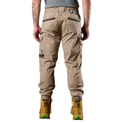 Person wearing beige cargo pants with visible branding on a white background