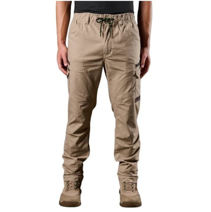 Beige cargo pants worn by a person on a white background