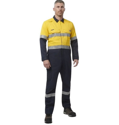 Person wearing a yellow and navy blue work jumpsuit with reflective stripes on a white background