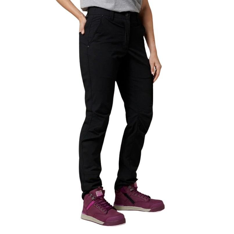 Person wearing black pants and purple shoes on a white background