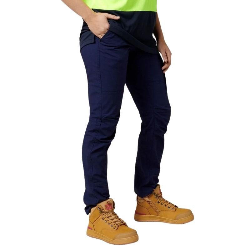 Person wearing navy pants and yellow boots on a white background