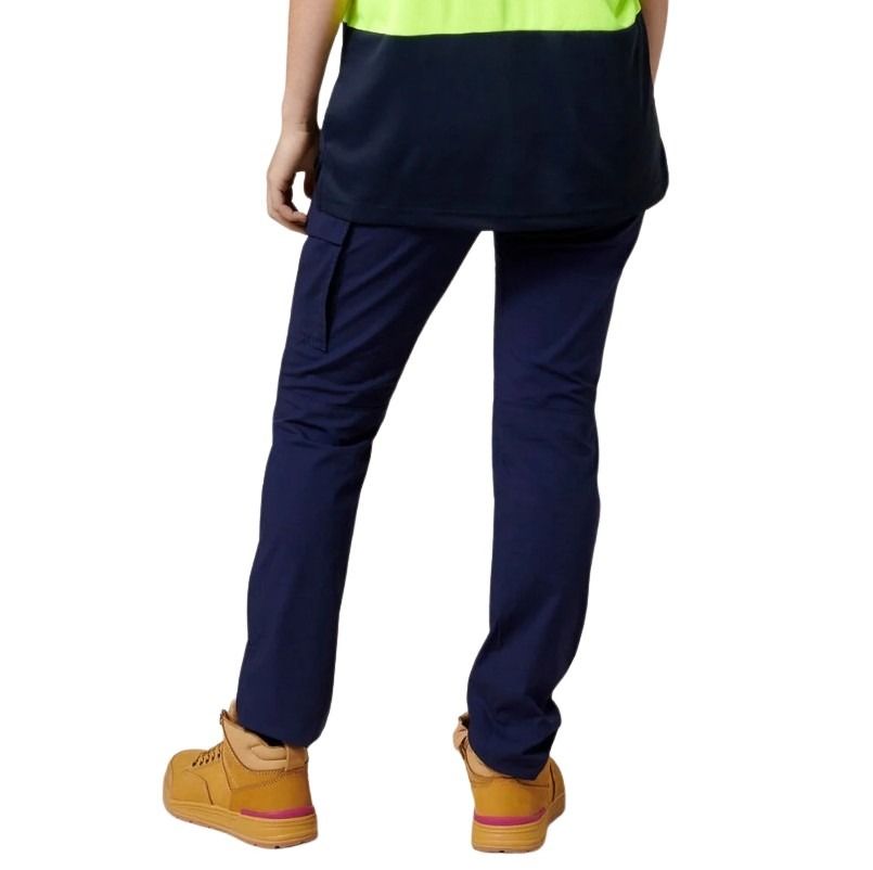 Person wearing navy pants and tan shoes on a white background